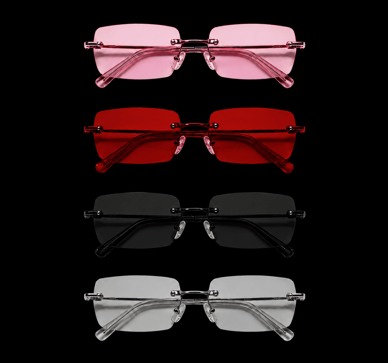 Four pairs of Glosswear rimless sunglasses stacked in pink, red, black and clear, each with a fine metal bridge and a tinted lens.